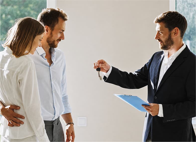 Agent handing over keys to new property owners