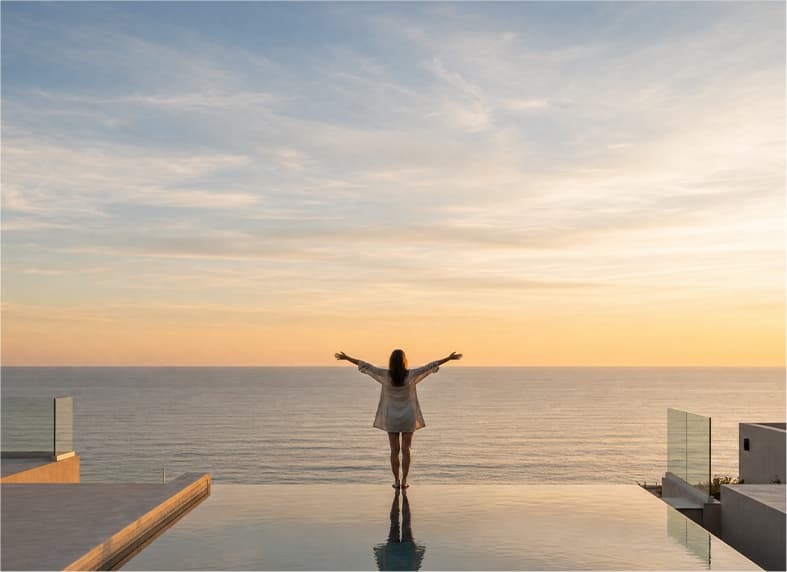 Person overlooking the sea from a terrace